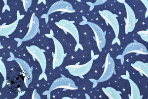 Jersey "Dolphin" als Digitaldruck.  Auf diesem Dessin findet man zauberhafte Delfine auf dunkelblauem Hintergrund.  Wunderschönes maritimes Dessin - angenehm im Griff, quer-elastisch. Jersey eignet sich besonders gut für die Herstellung von weich fließenden Kleidungsstücken, wie z.B. Tuniken, Kleidern, Röcken, T-Shirts, etc. - Nähen Kinder - Kinderstoff- Glückpunkt